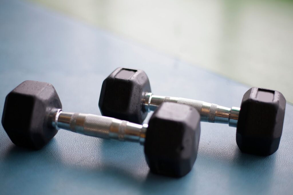 Pair of black hex dumbbells on a workout mat